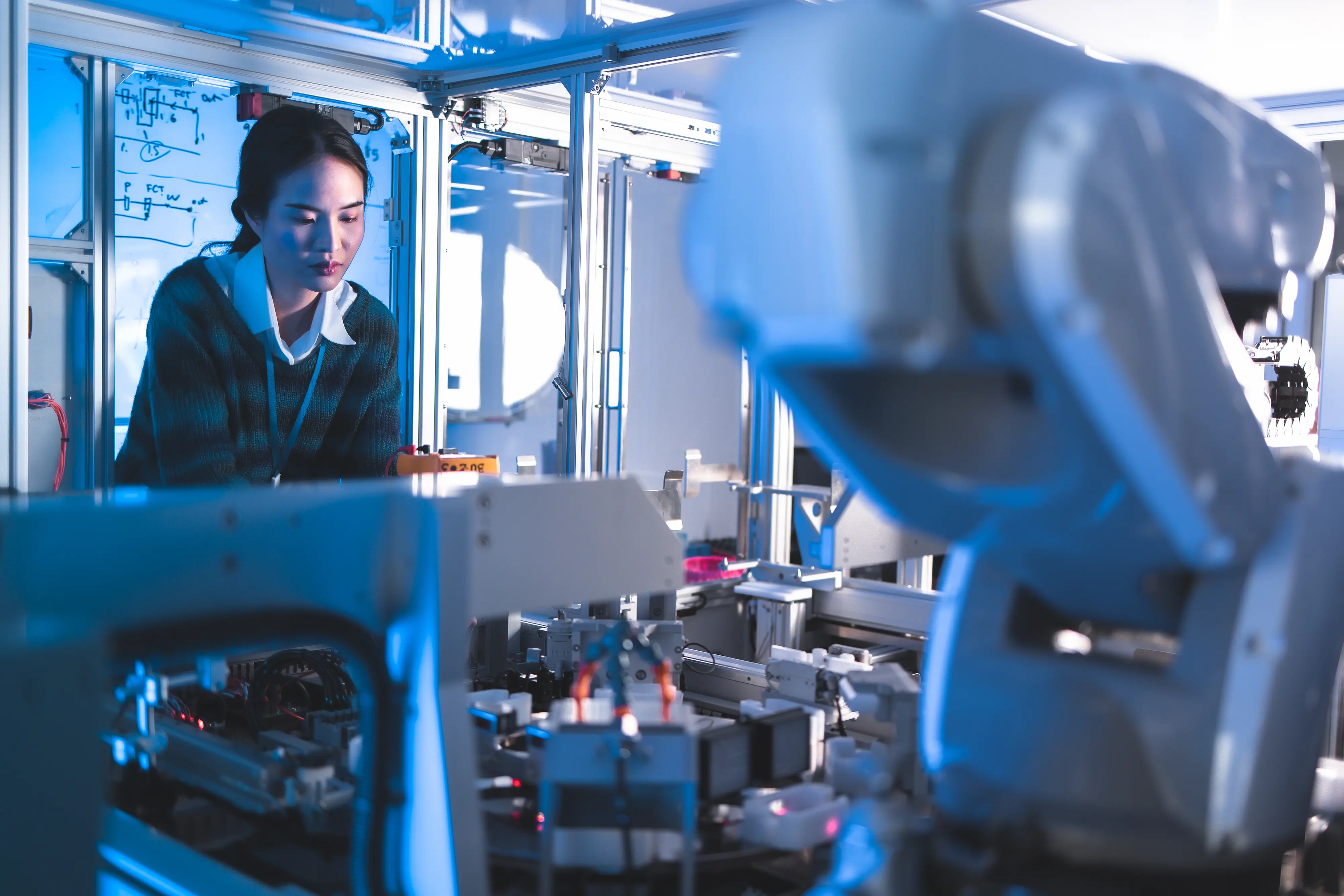 AI Business Automation in Canada Female Engineers Maintenance Robot Arm at Lab. She are in a High Tech Research Laboratory with Modern Equipment. Technology and Innovation Concept.Professional Japanese Development Engineer is Testing an Artificial Intelligence.start up concept.